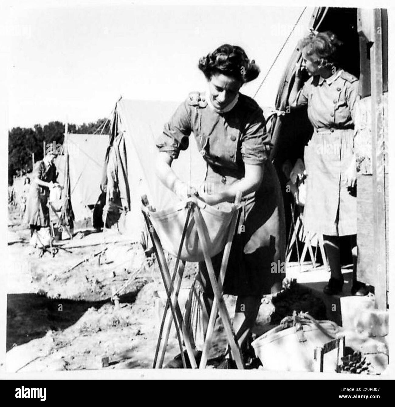 NORTH AFRICAA DAY IN THE LIFE OF A NURSE - Washing her own clothes outside her tent. Photographic negative , British Army Stock Photo