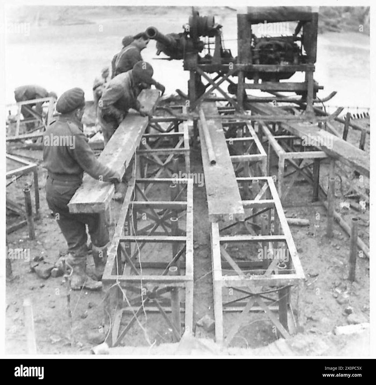 The Eighth Army lays the first tier of construction on steel piping ...