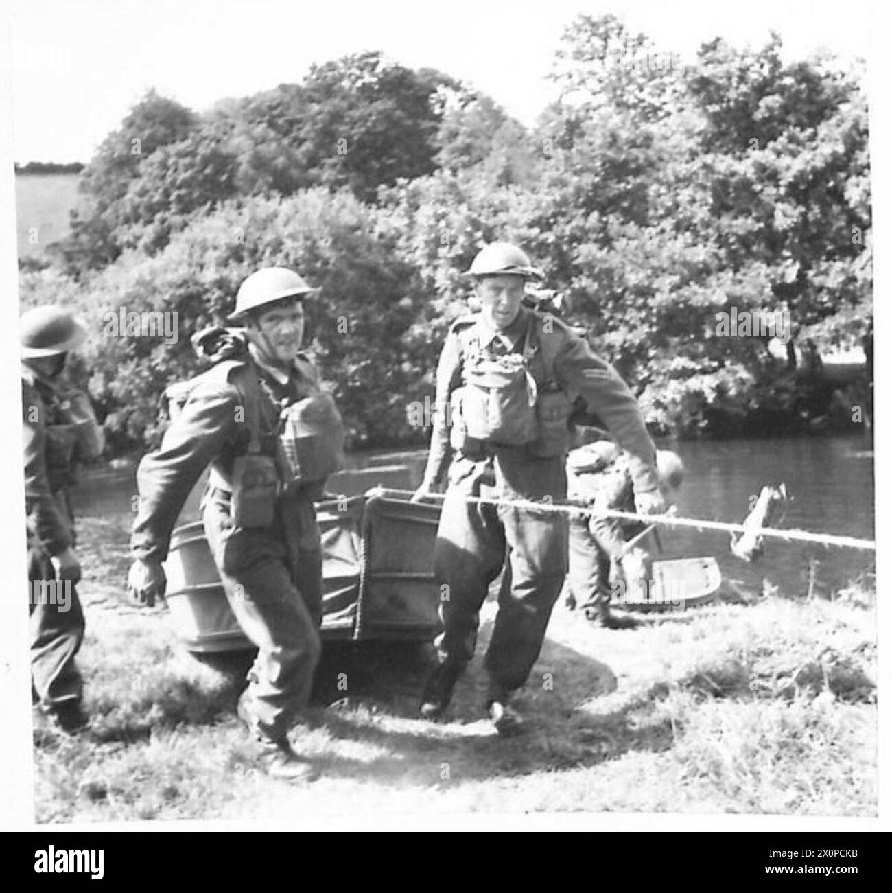 A COMBINED ARMY AND HOME GUARD EXERCISE - Home Guards embarking under the watchful eye of the Royal Marines who were in charge of the embarkation of Home Guards to cross the river in assault boats. Photographic negative , British Army Stock Photo
