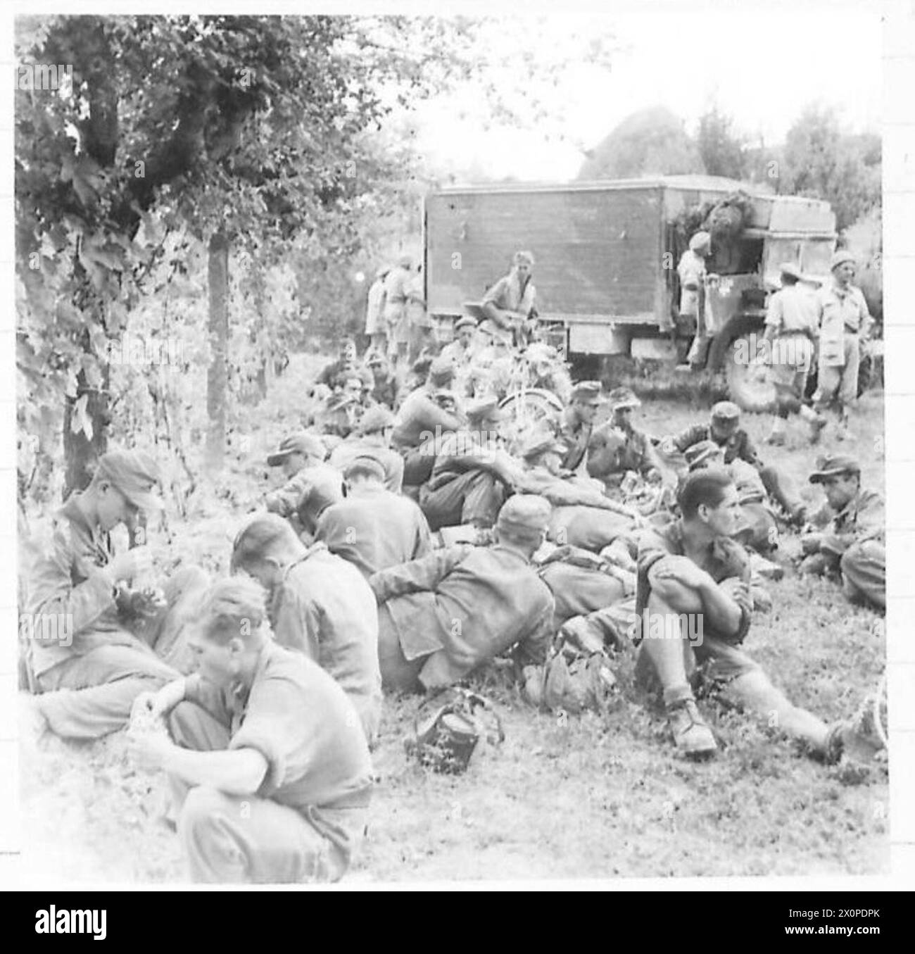 EIGHTH ARMY ADVANCE andGOTHIC LINE DEFENCES - German Panzer Grenadier prisoners, taken by 139 Brigade, take their first rest for some time as they await interrogation at Brigade Headquarters. Photographic negative , British Army Stock Photo