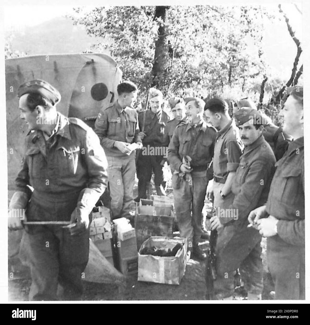 ITALY : EIGHTH ARMY : NEWFOUNDLAND GUNNERS IN ITALY - Bdr. W.E.G. Hopkins of London gives out NAAFI rations to R.H.Q. personnel. He is serving Gnr. Coady of St. Johns, Newfoundland. Photographic negative , British Army Stock Photo