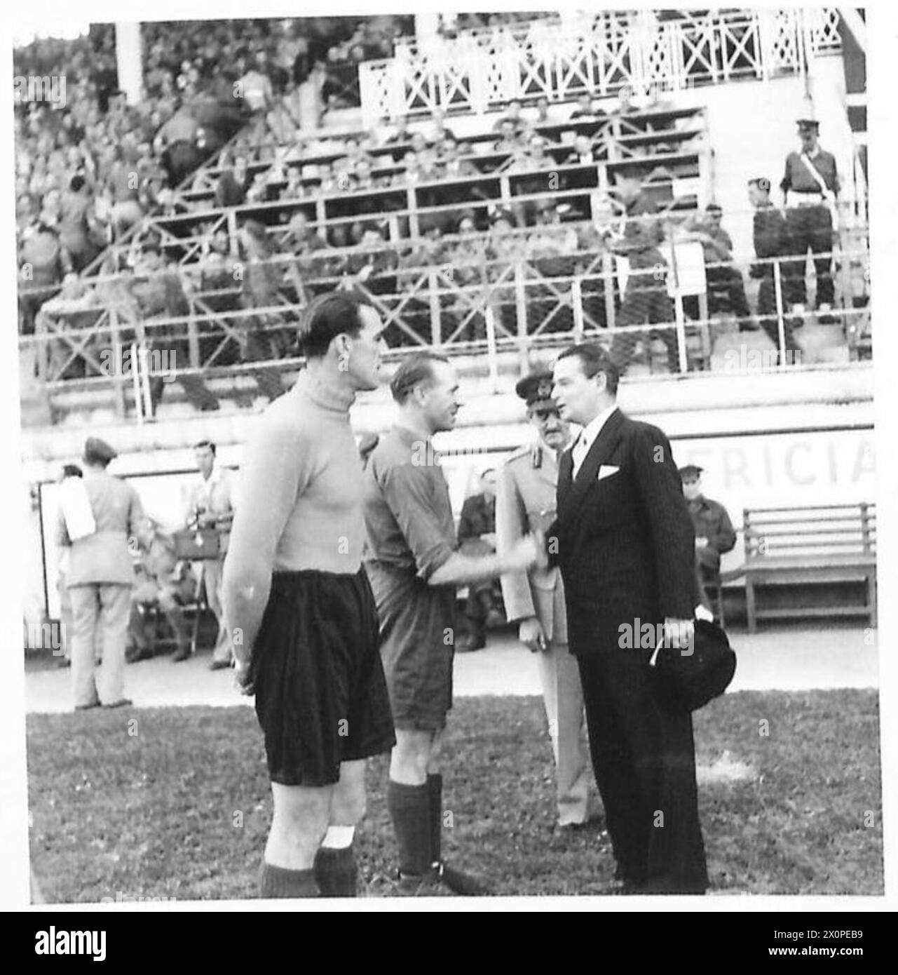 WEEK-END SPORT IN C.M.F. - Sir Noel Charles, British Ambassador, is introduced to the captain of the United Kingdom team - CSM (I) Busby of Liverpool and England. Photographic negative , British Army Stock Photo