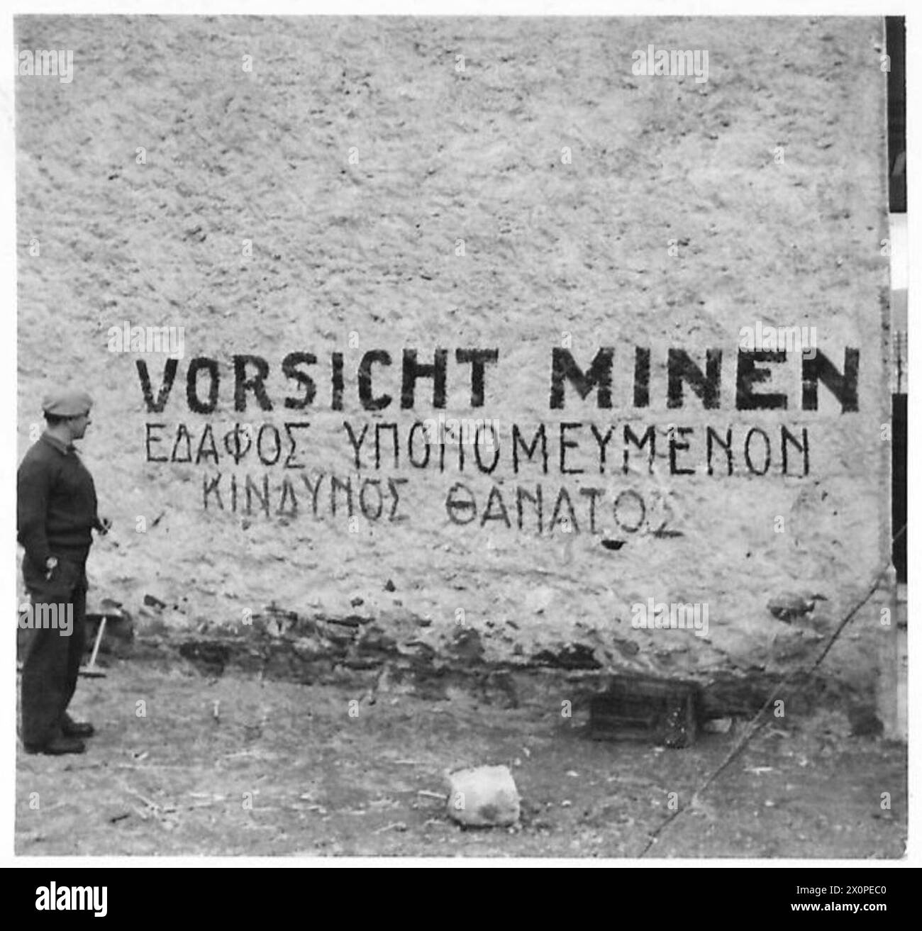 AEGEAN ISLANDS REOCCUPIED BY ALLIED FORCESTHE ISLAND OF KHIOS - CSM George Simmons of Maida Vale, London, who served in Greece in 1941, looks at one of the many mine warnings painted on the sides of buildings. Photographic negative , British Army Stock Photo