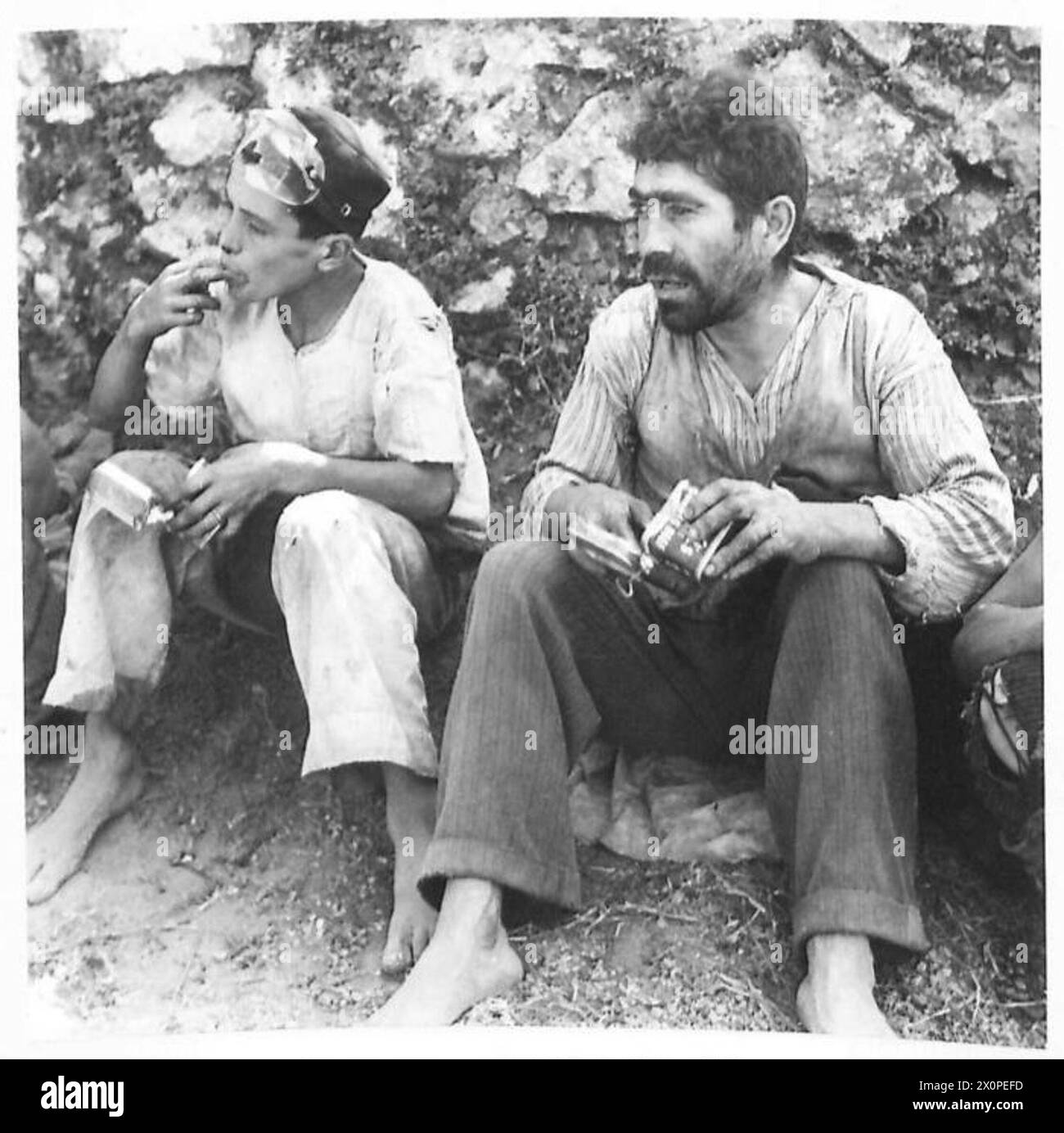 Soldiers of the Fifth Army enjoy rations from tins during the invasion ...