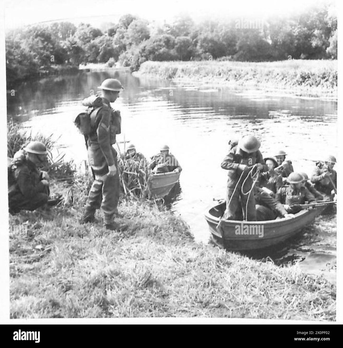 A COMBINED ARMY AND HOME GUARD EXERCISE - Home Guards embarking under the watchful eye of the Royal Marines who were in charge of the embarkation of Home Guards to cross the river in assault boats. Photographic negative , British Army Stock Photo
