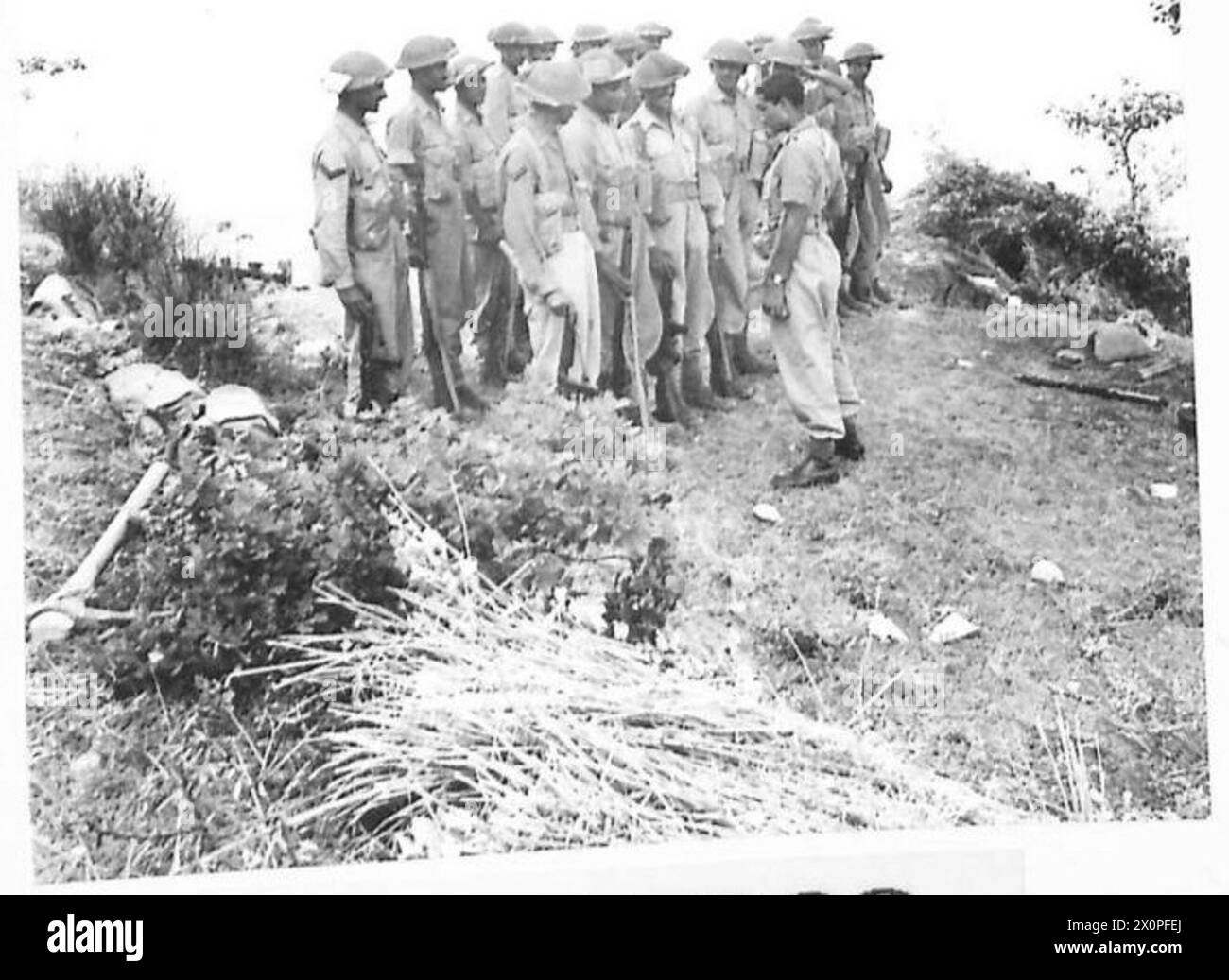 FIFTH ARMY : VARIOUS - A patrol being briefed before mopping up stray German positions. The enemy often leaves two or three light machine gunners behind in houses or buildings, which are by-passed by the main drive and mopped up later. Photographic negative , British Army Stock Photo