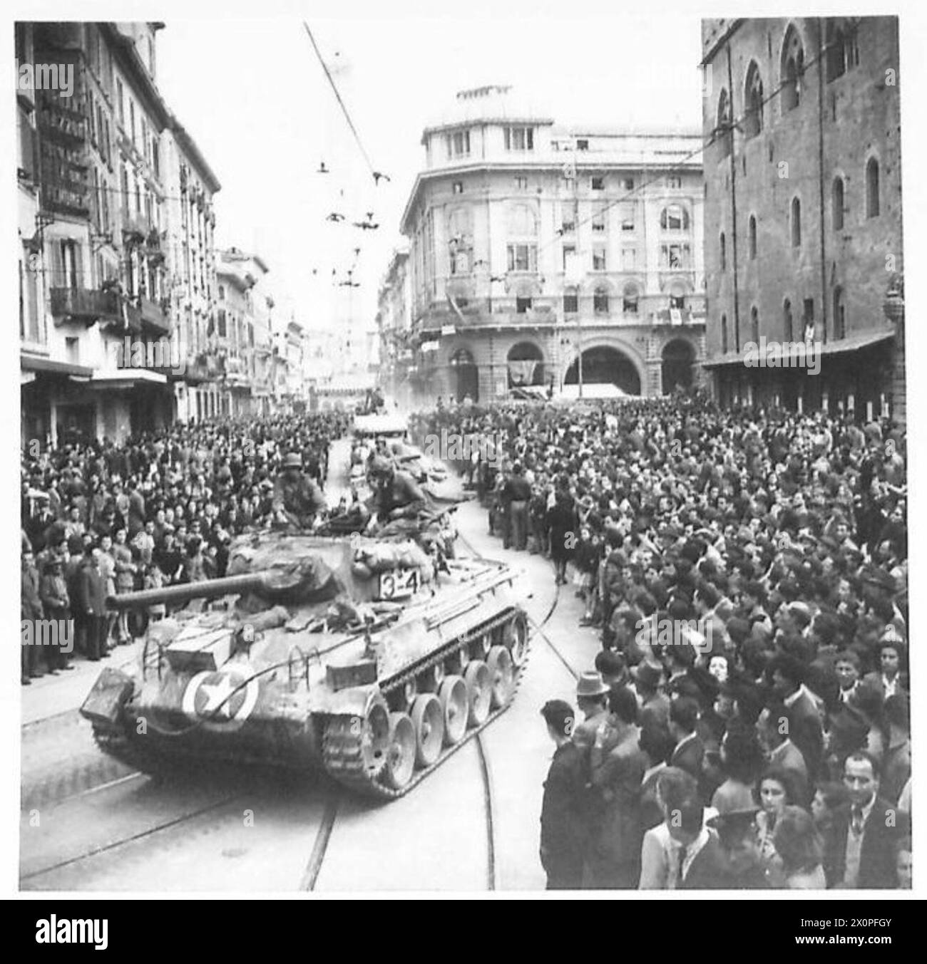BOLOGNA : VARIOUS - Huge crowds of Bolognese citizens clap and cheer as armour passes through the streets. Photographic negative , British Army Stock Photo