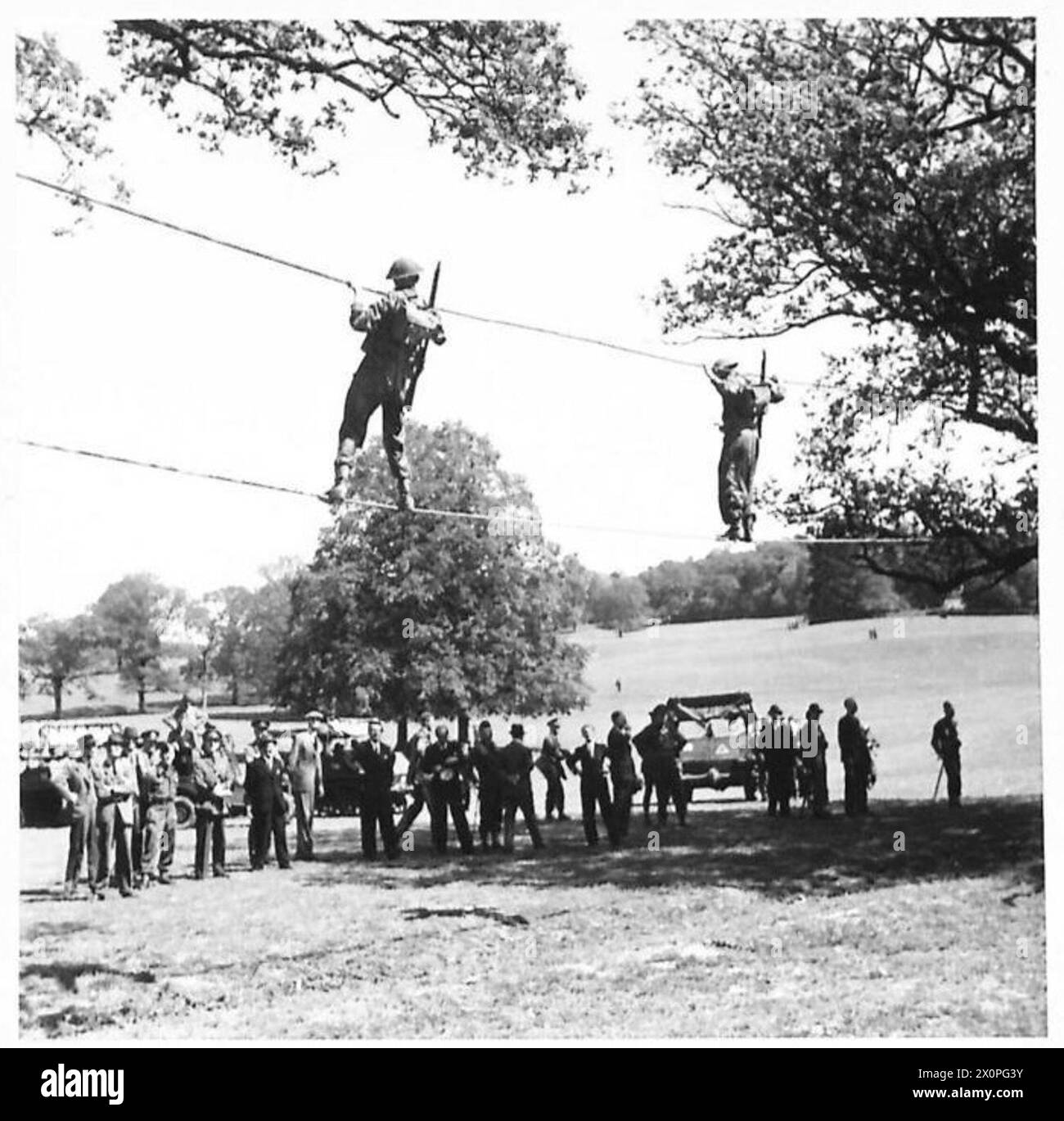 Members of Parliament observe British Army troops crossing a rope ...