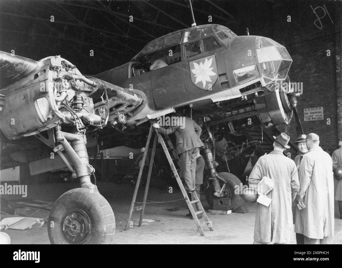 WW2 Photo of German personnel examining parked plane. WW2 Photo of German personnel examining parked plane.