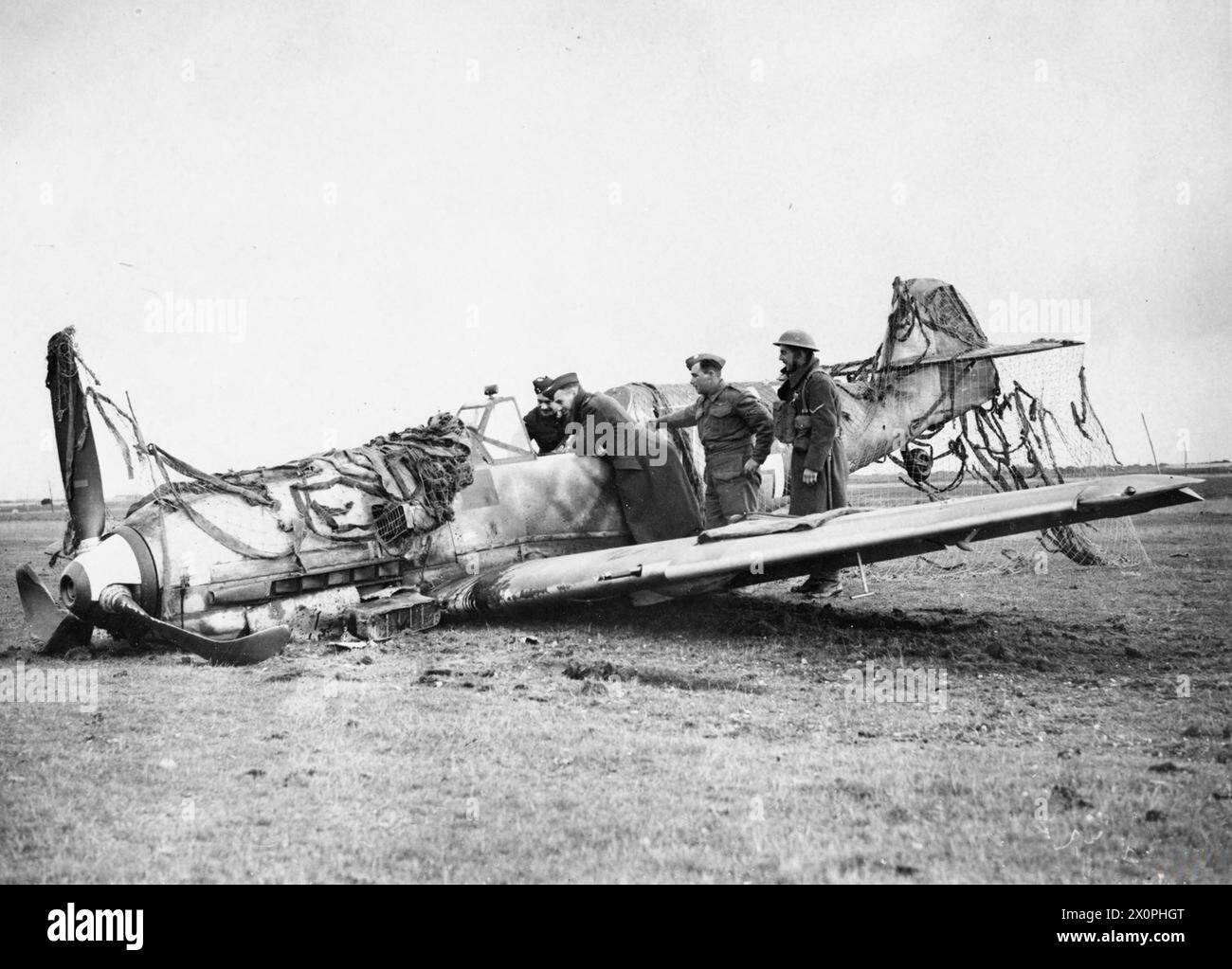 RAF Personnel And Soldiers Inspecting Messerschmitt Bf 109E 4 Black 7 raf-personnel-and-soldiers-inspecting-messerschmitt-bf-109e-4-black-7