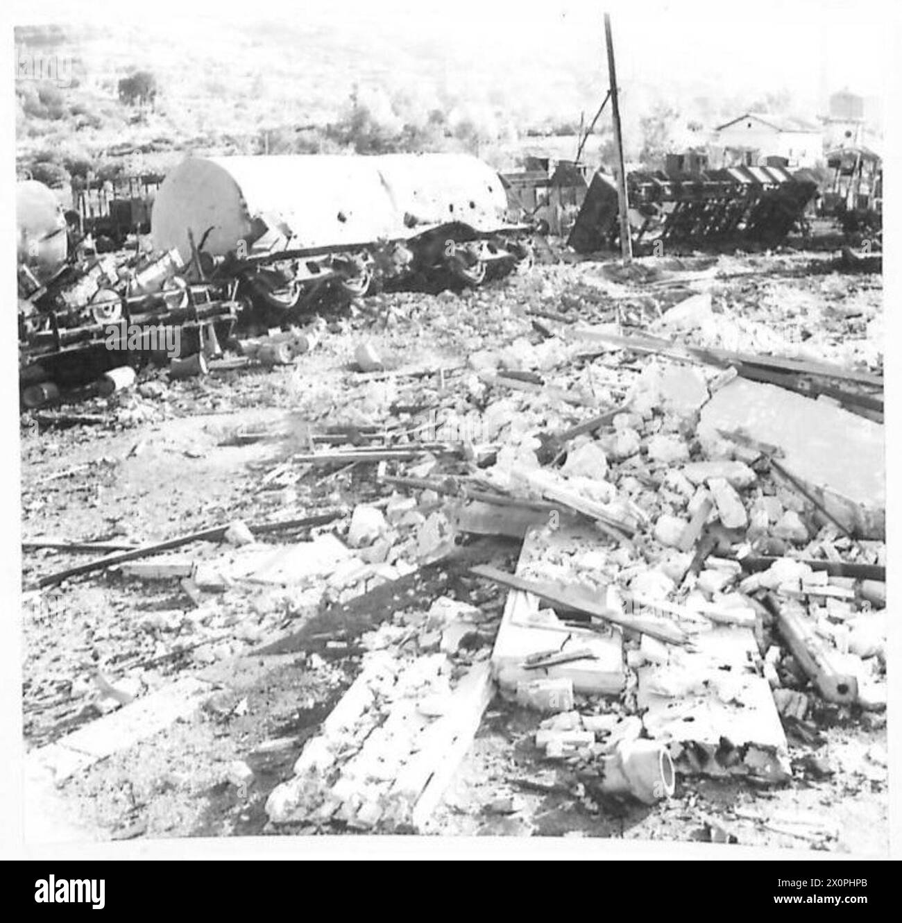 THE BRITISH ARMY IN NORTH AFRICA, SICILY, ITALY, THE BALKANS AND AUSTRIA 1942-1946 - The announcement by the RAF that bombers of the CMF had attacked coastal railway communications in Italy does not convey very much to a civilian mind. These pictures show the results of such a raid on the railway station at Vibo Valentia which stands on the outskirts of the small West coast port of Porto Di Danta Venera in the Province of Calabria. Trucks containing German planes, aero engines, petrol, coal and ammunition were all consumed in the fires that followed the raid. Even the wooden sleepers were burn Stock Photo