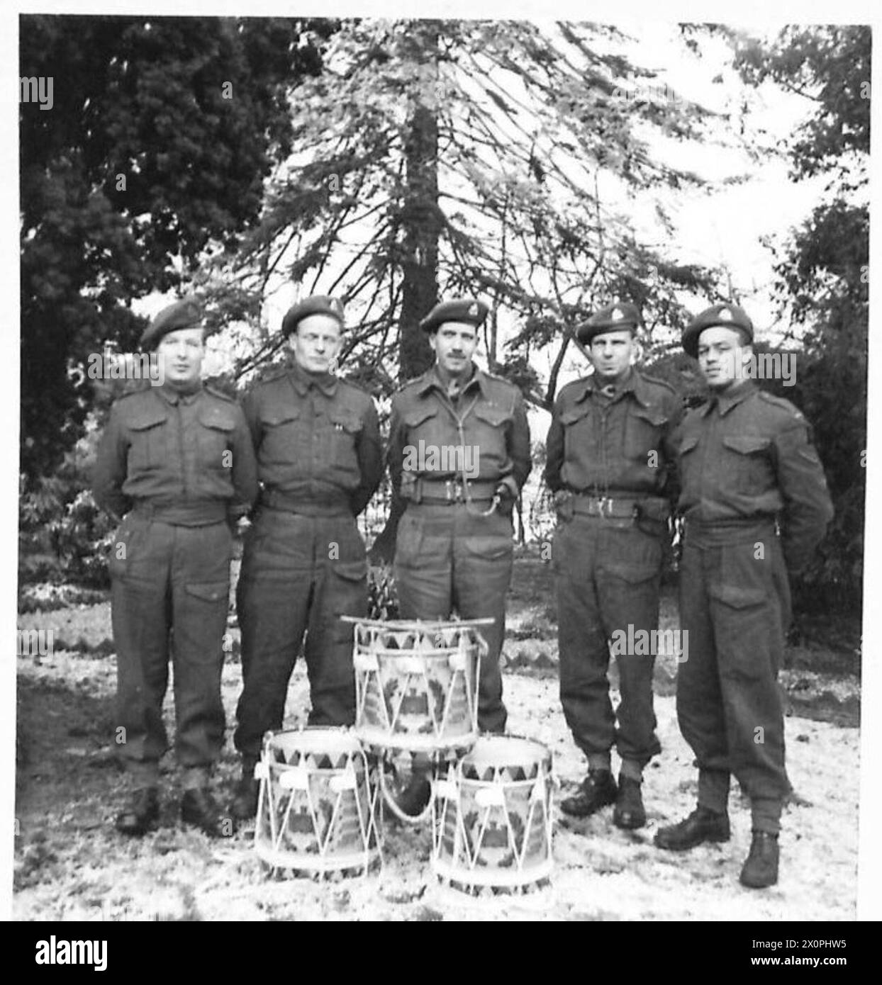 STORY OF THE DRUMS - The three drums, with five of the First Batt. Suffolks who were over in 1940 when the drums were hidden (L-R) Pte. A. Day, 5 New Street, Weymouth. L/Cpl. C. Clarke, 190 Green End Road, Cambridge, Lt-Col. R.E. Goodwin, DSO, 14 Westley Road, Bury St. Edmunds, Suffolk. RSM G. Trindini, 22, Wythes Road, Silvertown (a drummer for twelve years and now the band's instructor); L/Cpl Jack Hutchinson, Penn Farm. Cheddar. Photographic negative , British Army, 21st Army Group Stock Photo