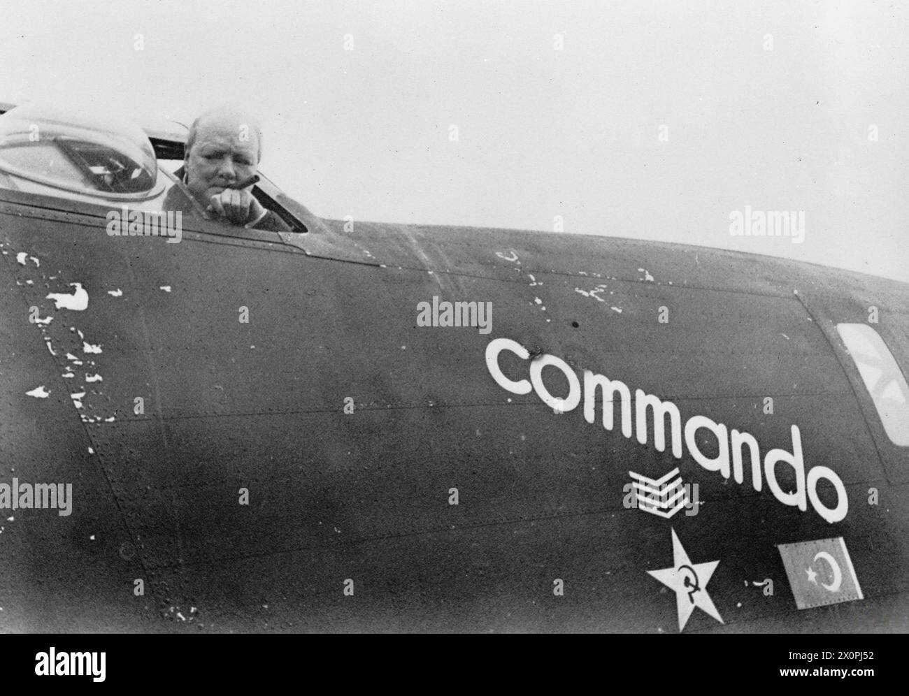 WINSTON CHURCHILL IN TURKEY DURING THE SECOND WORLD WAR - Winston Churchill looks out from his personal aircraft, a Consolidated B-24 Liberator, AL 504 'Commando', shortly before leaving Adana, Turkey, circa 22 April 1943. A black and white copy negative , Stock Photo
