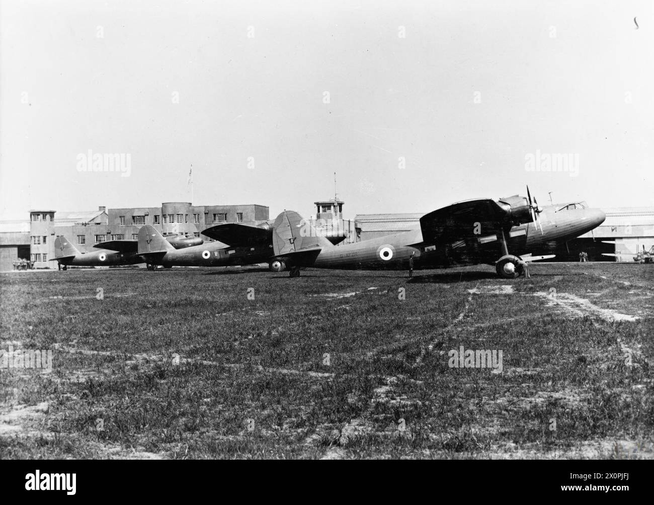 ROYAL AIR FORCE TRAINING COMMAND, 1939-1940. - Fokker F.XXXVI, G-AFZR, and Fokker F.XXIIs, G-AFZP and G-AFXR, of No. 1 Air Observer and Navigation School, parked in front of the airport buildings at Prestwick, Ayrshire. G-AFZR (formerly PH-AJA) was purchased from the Dutch airline KLM by the RAF in 1939. It was flown and maintained by Scottish Aviation Ltd, Prestwick, under its civil registration, and served alongside the F.XXIIs as a navigational trainer, initially with No. 12 Elementary Flying Training School, followed by 1 AONS. On 21 May 1940, G-AFZR crashed on take off from Prestwick Roya Stock Photo