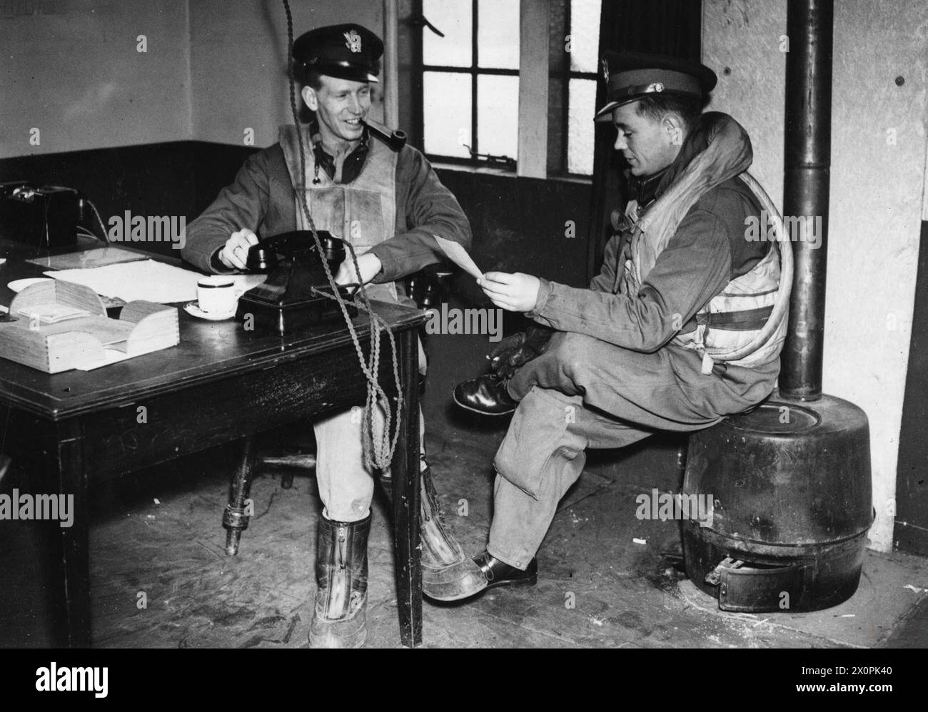 Lieutenant-Colonel Chesley G. Peterson and Major Oscar H. Coen of the US 4th Fighter Group are pictured at an air station in England after completing a mission, 1943. Stock Photo
