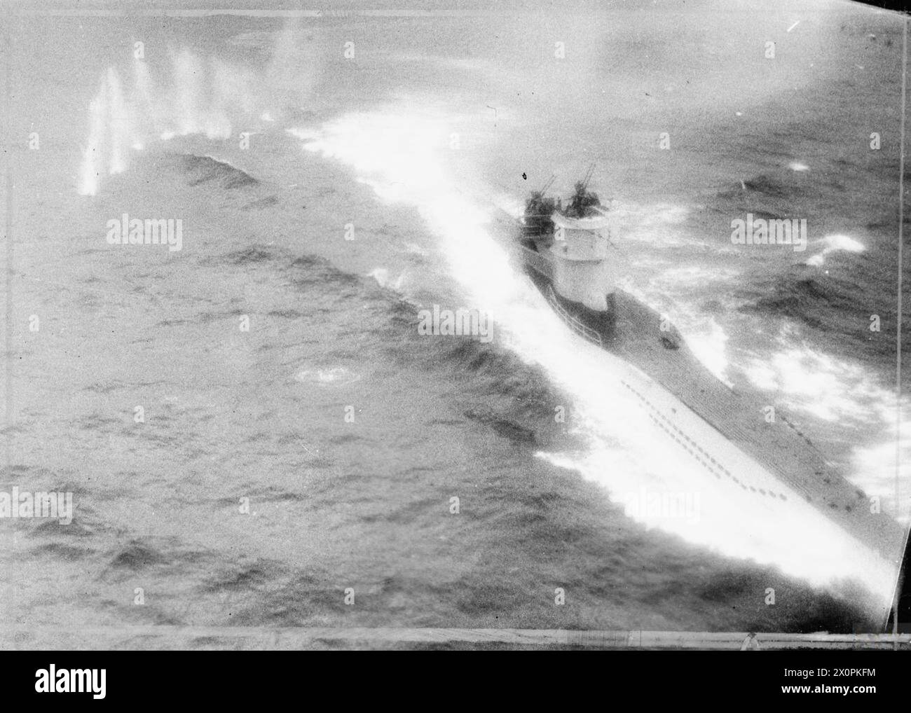 ROYAL AIR FORCE COASTAL COMMAND, 1939-1945. - Oblique photograph taken from Consolidated Catalina Mark IVA, JV928 'Y', of No. 210 Squadron RAF during an attack on German type VIIC submarine U-347 west of the Lofoten Islands. After an initial attack in which the Catalina's depth charges failed to release, the captain, Flying Officer J A Cruickshank, made a second run from astern, through intense fire from the U-boat which killed the Navigator (Flying Officer J.C. Dickson) and seriously wounded Cruickshank and three other members of the crew. The photograph shows the splashes from the first of s Stock Photo