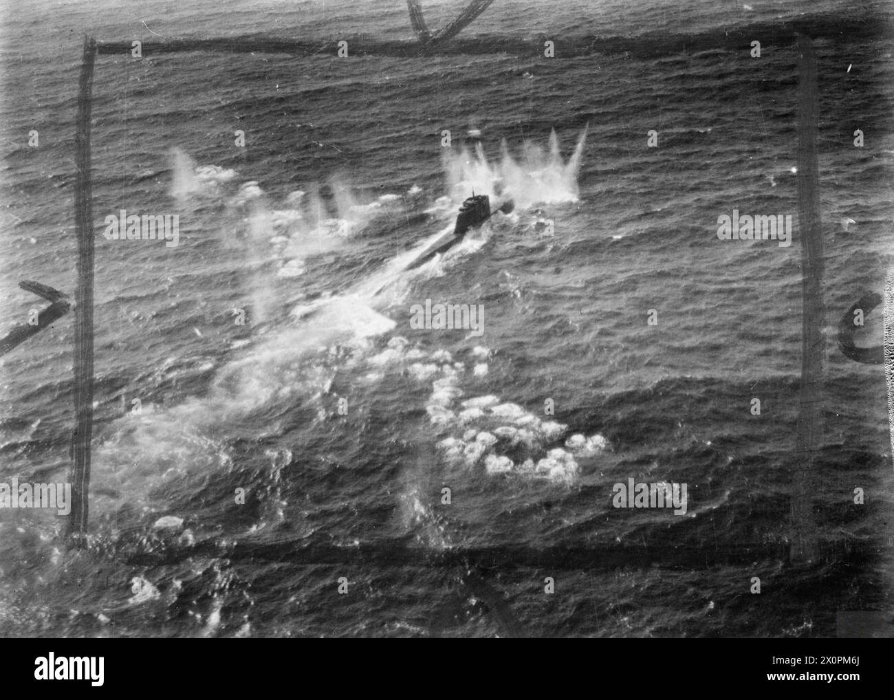 ROYAL AIR FORCE COASTAL COMMAND, 1939-1945. - A German type XXI submarine, U-2502, comes under cannon fire from a De Havilland Mosquito FB Mark VI during an attack on four surfaced U-boats and an M-class minsweeper escort in the Kattegat by 22 Mosquitos of the Banff Strike Wing. U-2502 received only slight damage, but a type VIIC submarine was sunk, a type XXIII seriously damaged and the minesweeper left burning Royal Air Force, 18 Group, German Navy (Third Reich), U2502 Stock Photo