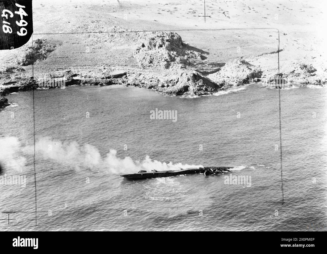 ROYAL AIR FORCE OPERATIONS IN MALTA, GIBRALTAR AND THE MEDITERRANEAN, 1940-1945. - German submarineType VIIC, U-617, on fire and lying on her port side after being beached off the Moroccan coast near Melilla, as a result of damage sustained in an attack by two Gibraltar-based Vickers Wellington Mark VIIIs of No. 179 Squadron RAF, in the early morning of 12 September 1943. Photograph taken from a Lockheed Hudson of No. 48 Squadron RAF, one of a number of aircraft subsequently despatched from Gibraltar to continue the attack. All of U-617's crew reached shore safely, and she was eventually destr Stock Photo