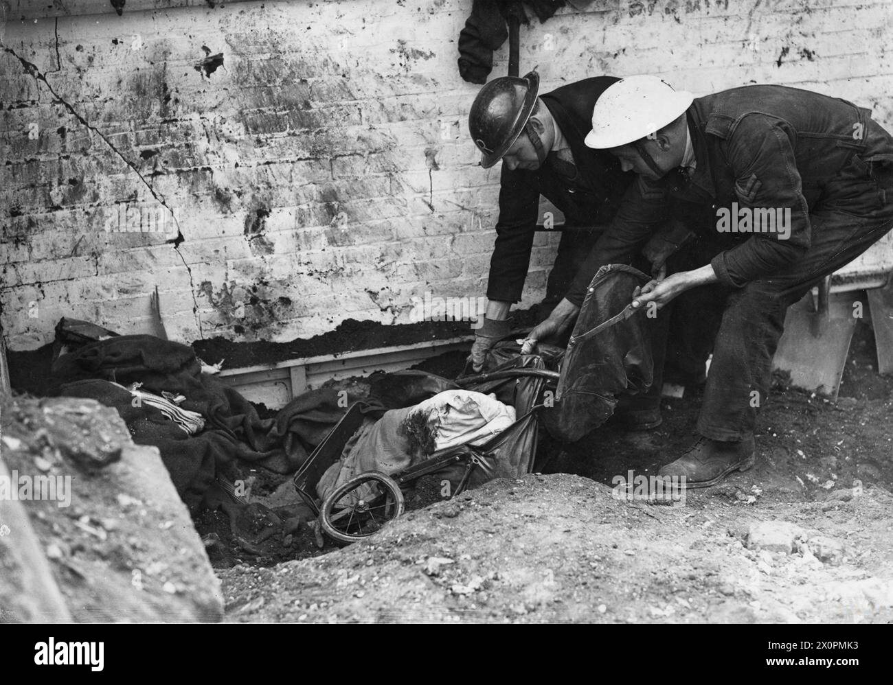 ARP MEDICAL 1940 ARP men removing damaged pram with a dead baby in wrapped in blood stained