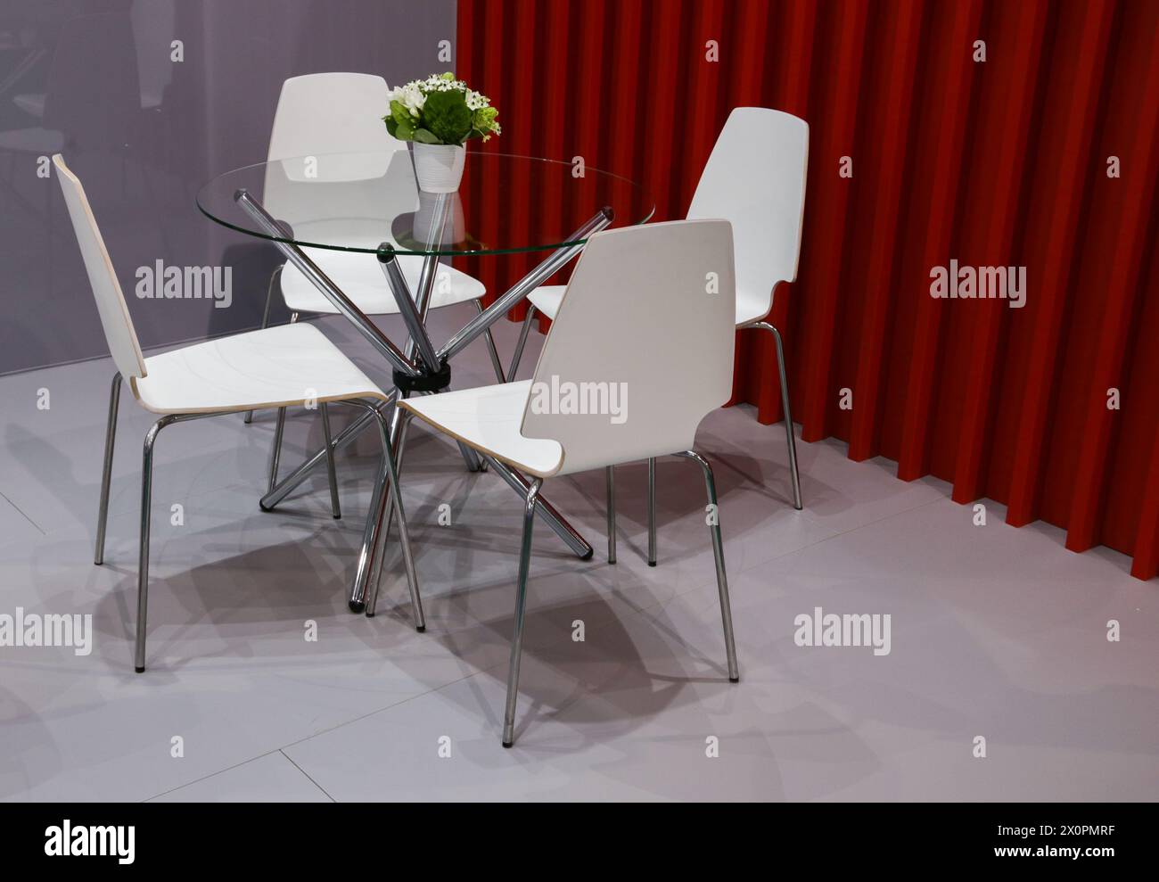 Modern open plan office interior with 4 chairs and round glass transparent table. Stock Photo