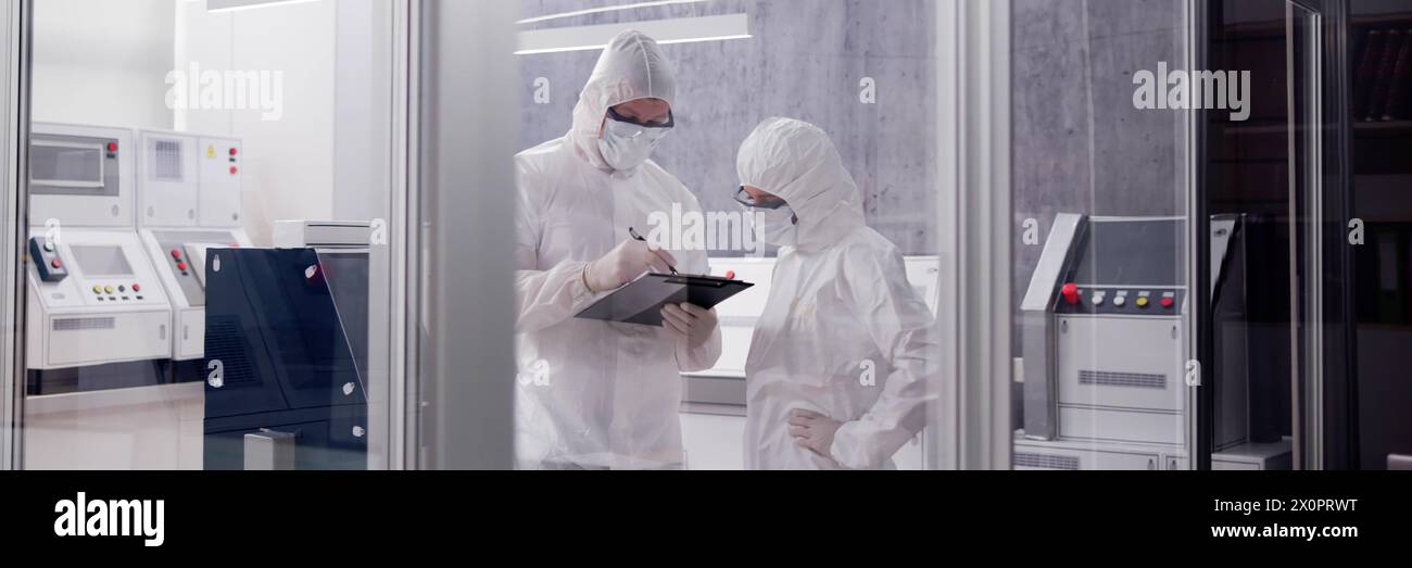 Engineer in clean factory room using tablet in laboratory Stock Photo