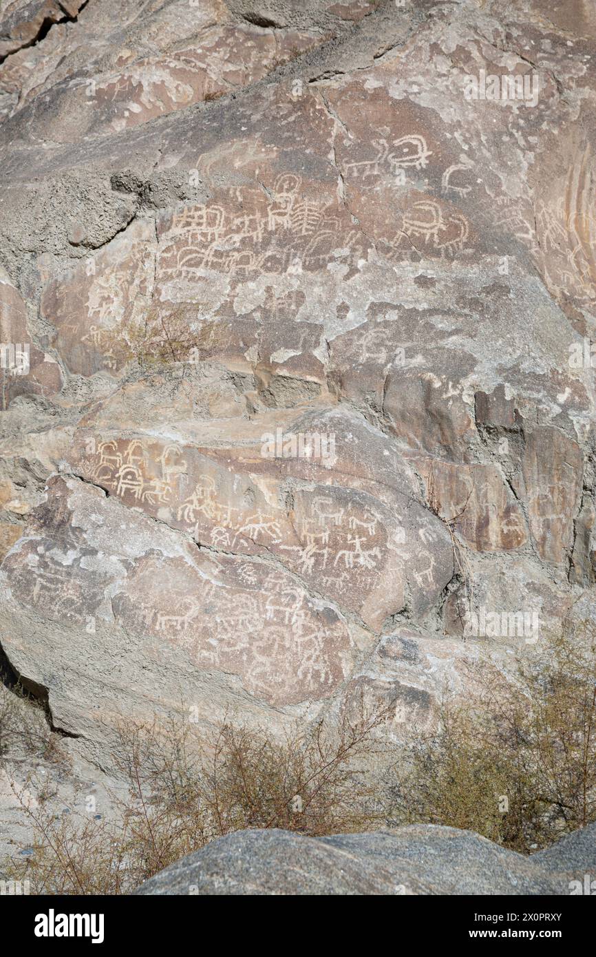 Prehistoric Petroglyphs in Hunza valley, sacred rock of Hunza, rock carvings in Gilgit Baltistan, Pakistan. Stock Photo