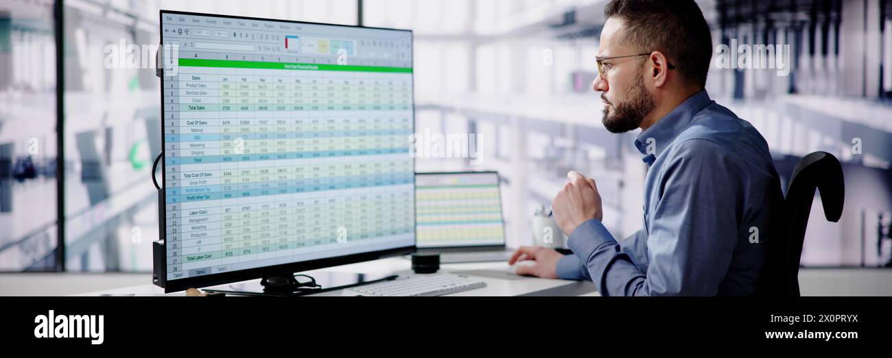 Medical analyst man reviewing data on spreadsheets Stock Photo