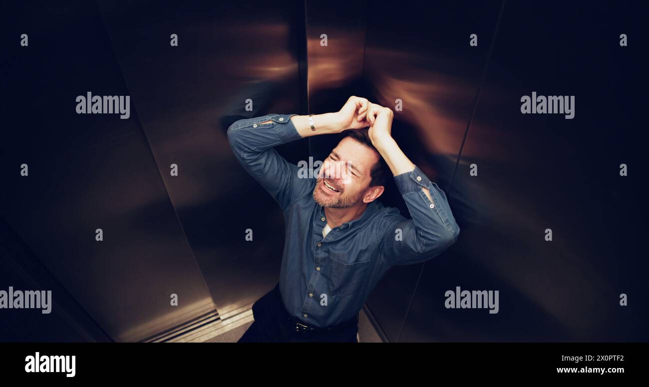Man Suffering From Claustrophobia Trapped Inside Elevator Stock Photo