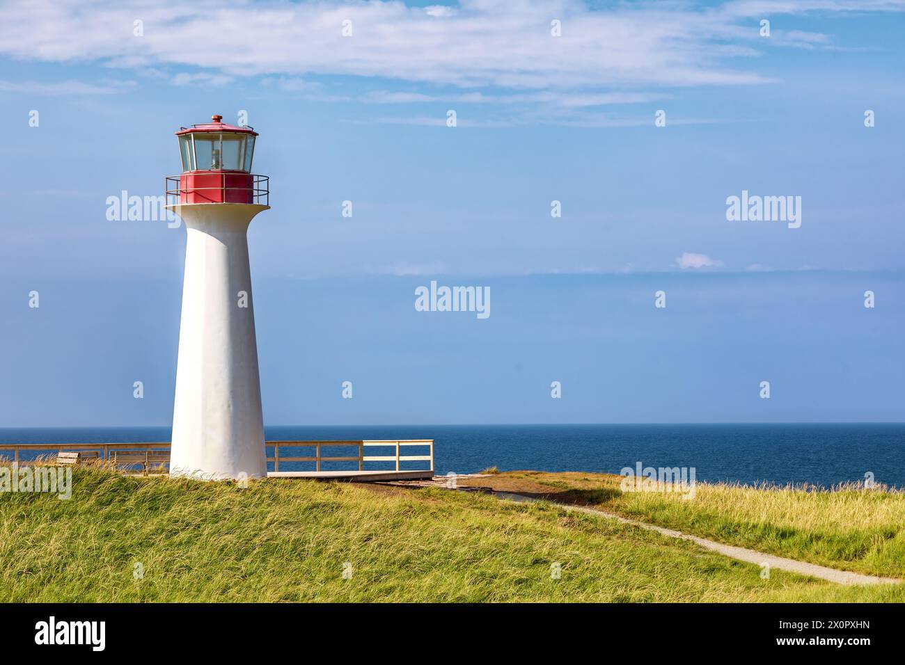 Borgot, or Cape Herisse lighthouse of Cap aux Meules, Magdalen Islands, Canada. The lighthouse stands on the rugged red cliffs of the Etang du Nord. Stock Photo