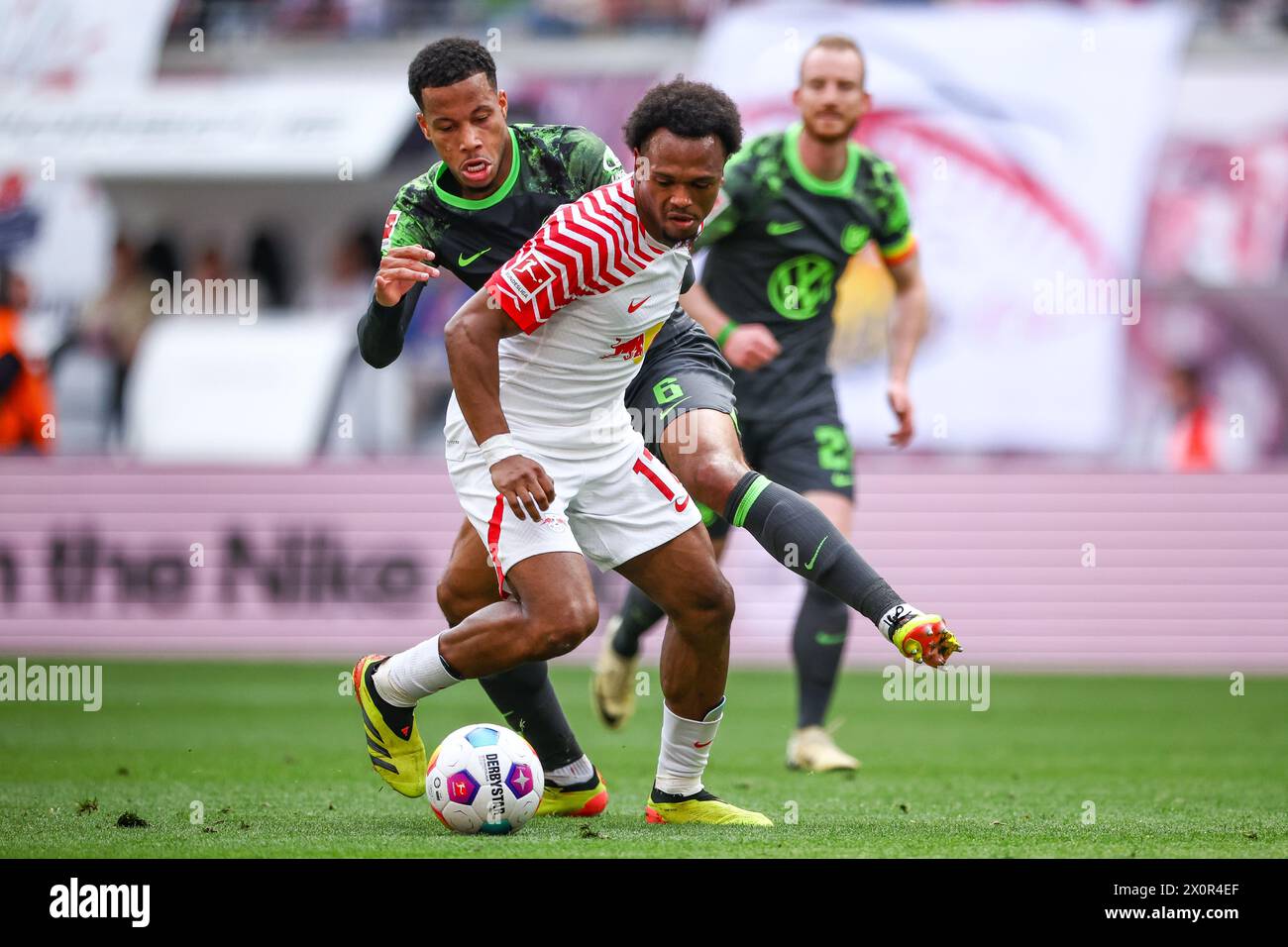 Leipzig, Germany. 13th Apr, 2024. Soccer: Bundesliga, RB Leipzig - VfL Wolfsburg, matchday 29 at the Red Bull Arena. Leipzig's player Lois Openda (v) and Wolfsburg's Aster Vranckx in a duel. Credit: Jan Woitas/dpa - IMPORTANT NOTE: In accordance with the regulations of the DFL German Football League and the DFB German Football Association, it is prohibited to utilize or have utilized photographs taken in the stadium and/or of the match in the form of sequential images and/or video-like photo series./dpa/Alamy Live News Stock Photo