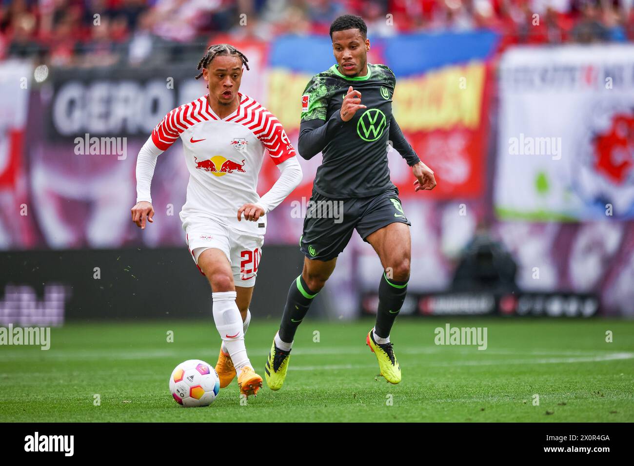 Leipzig, Germany. 13th Apr, 2024. Soccer: Bundesliga, RB Leipzig - VfL Wolfsburg, matchday 29 at the Red Bull Arena. Leipzig player Xavi Simons (l) and Wolfsburg's Aster Vranckx in a duel. Credit: Jan Woitas/dpa - IMPORTANT NOTE: In accordance with the regulations of the DFL German Football League and the DFB German Football Association, it is prohibited to utilize or have utilized photographs taken in the stadium and/or of the match in the form of sequential images and/or video-like photo series./dpa/Alamy Live News Stock Photo