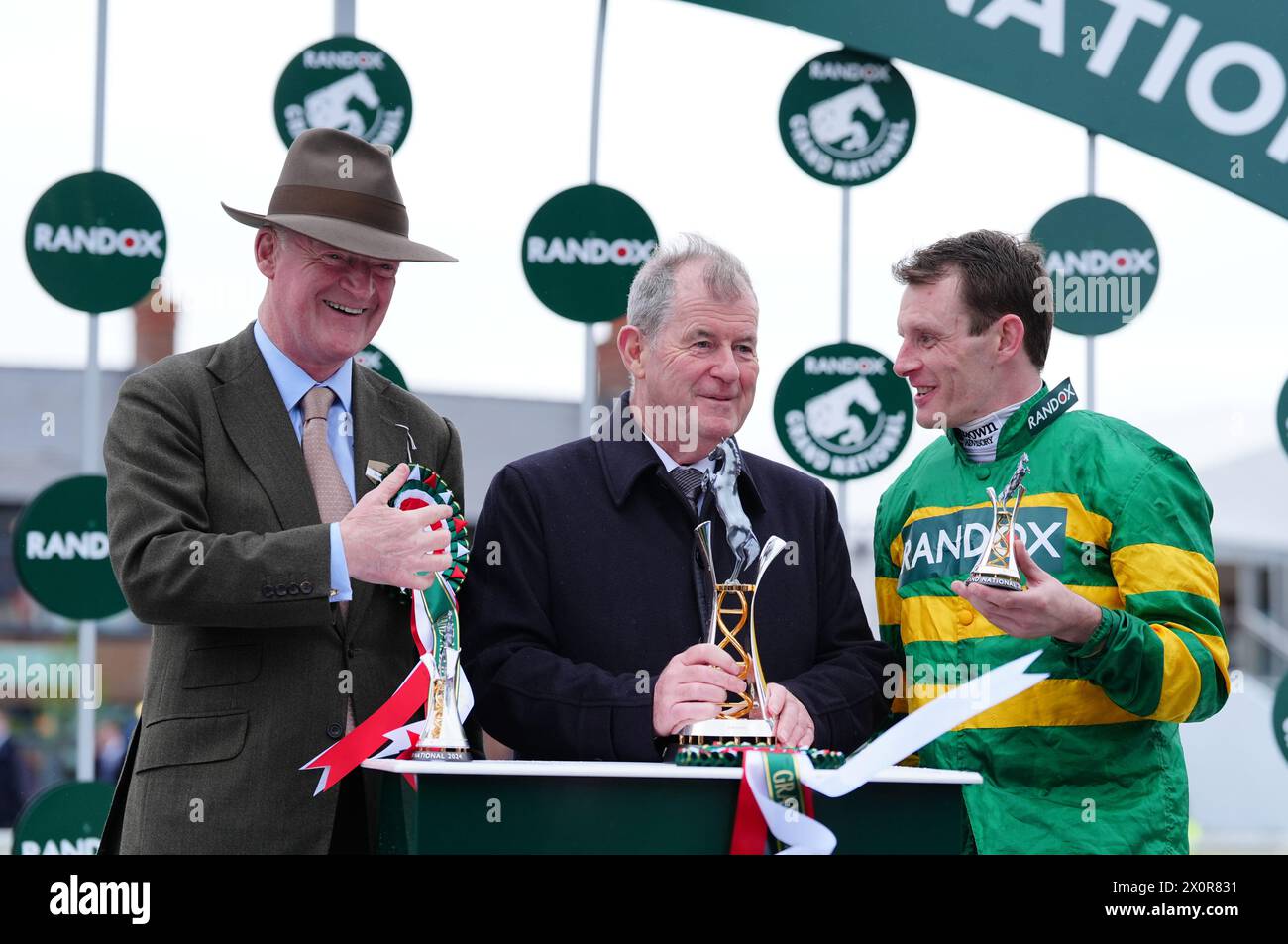 Trainer Willie Mullins, owner J. P. McManus and jockey Paul Townend after I Am Maximus won the Randox Grand National Handicap Chase on day three of the 2024 Randox Grand National Festival at Aintree Racecourse, Liverpool. Picture date: Saturday April 13, 2024. Stock Photo