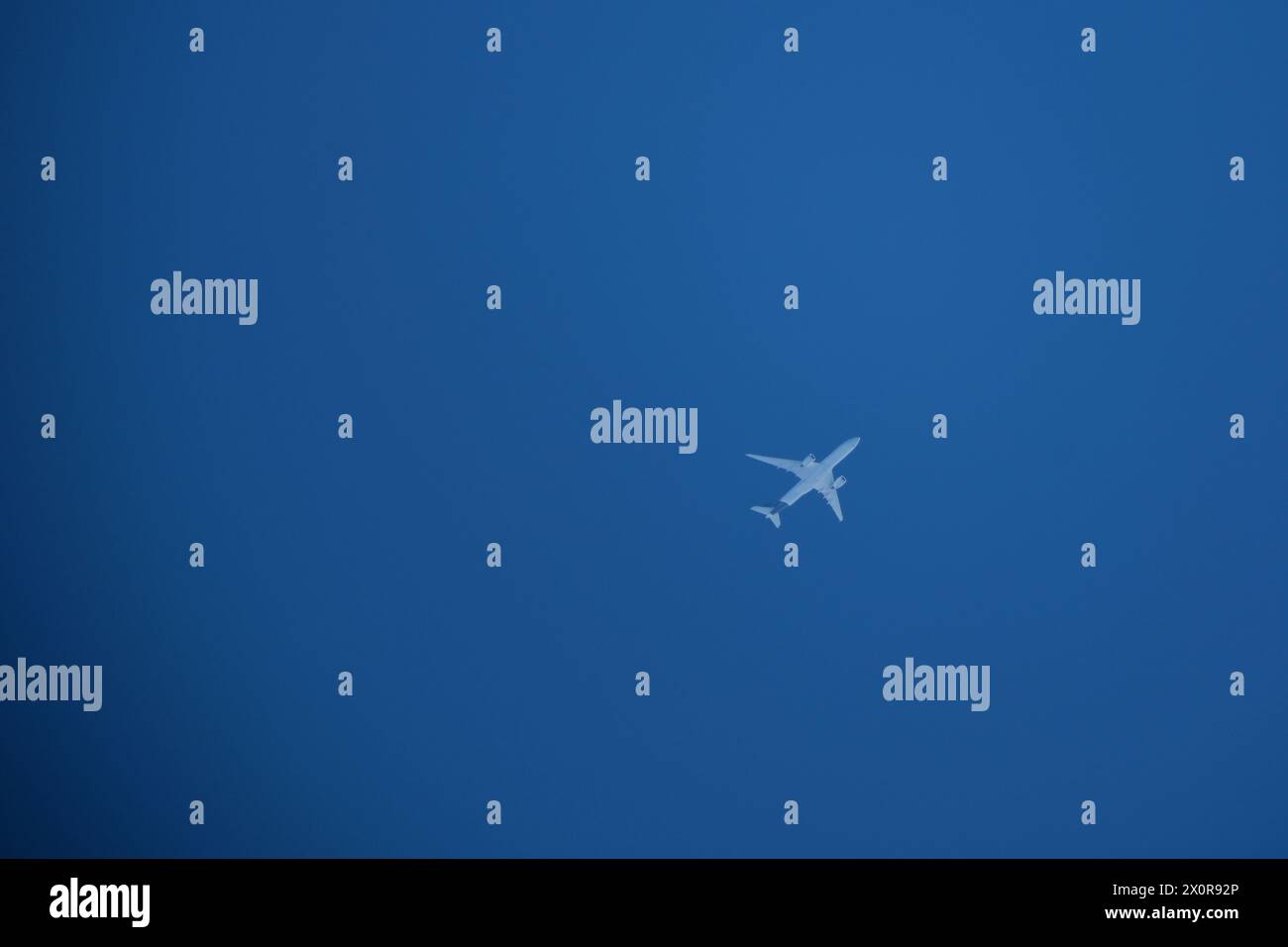 Airplane in the blue sky Stock Photo - Alamy