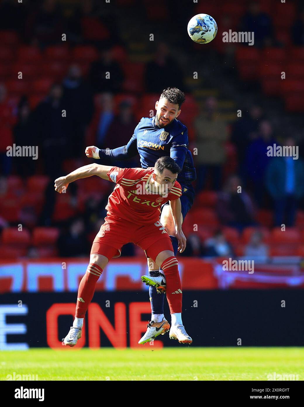 Pittodrie Stadium, Aberdeen, UK. 13th Apr, 2024. Scottish Premiership Football, Aberdeen versus Dundee; Antonio Portales of Dundee competes in the air with Bojan Miovski of Aberdeen Credit: Action Plus Sports/Alamy Live News Stock Photo