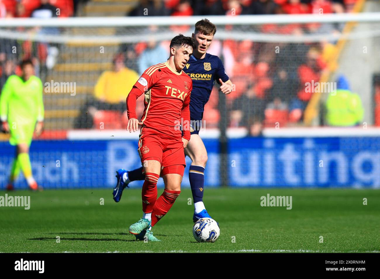 Pittodrie Stadium, Aberdeen, UK. 13th Apr, 2024. Scottish Premiership Football, Aberdeen versus Dundee; Jamie McGrath of Aberdeen and Aaron Donnelly of Dundee Credit: Action Plus Sports/Alamy Live News Stock Photo