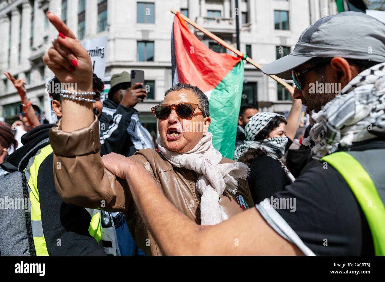 London, UK. 13 April 2024. Pro-Palestine supporters march by a Pro ...