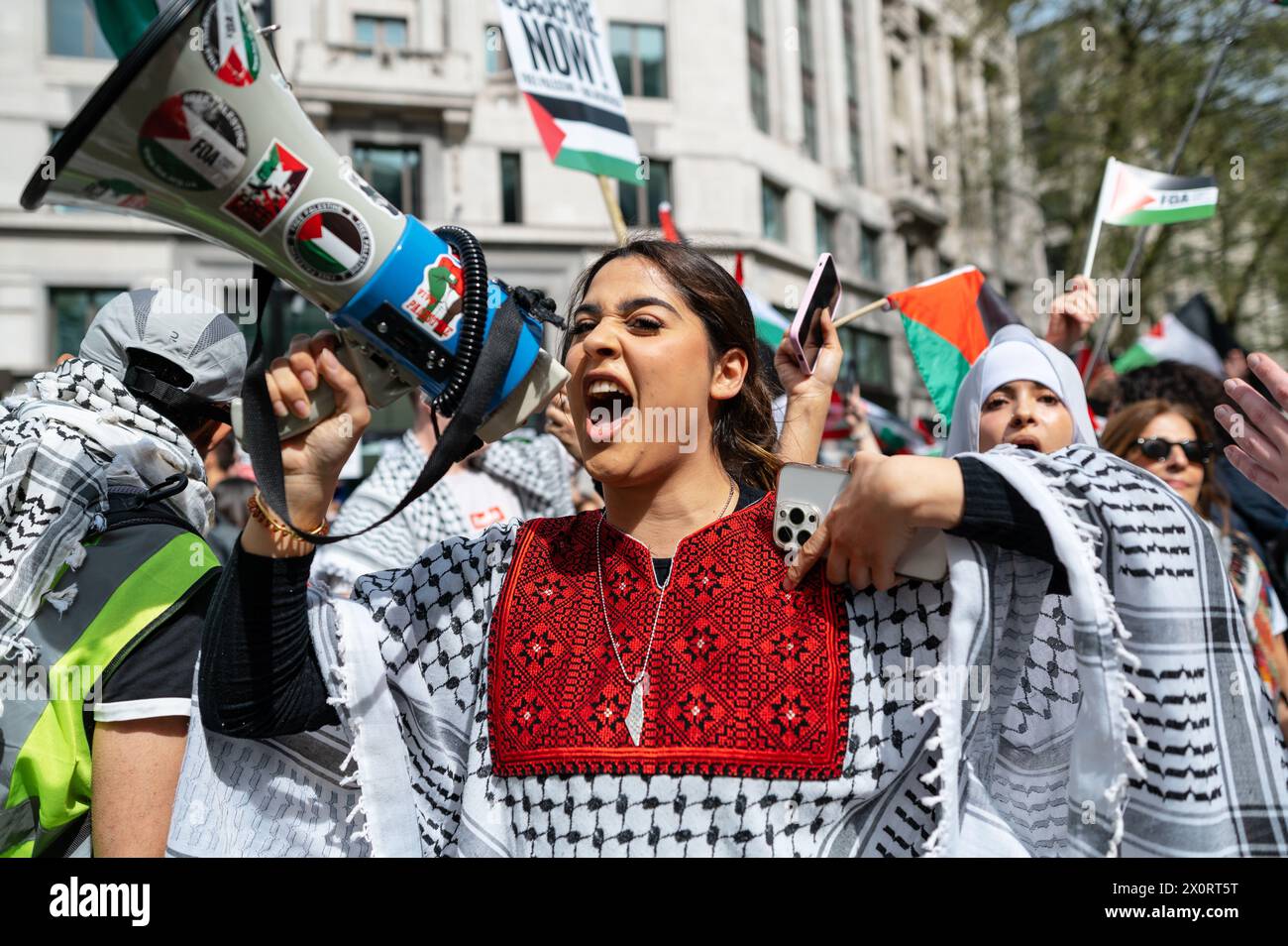 London, UK. 13 April 2024. Pro-Palestine supporters march by a Pro