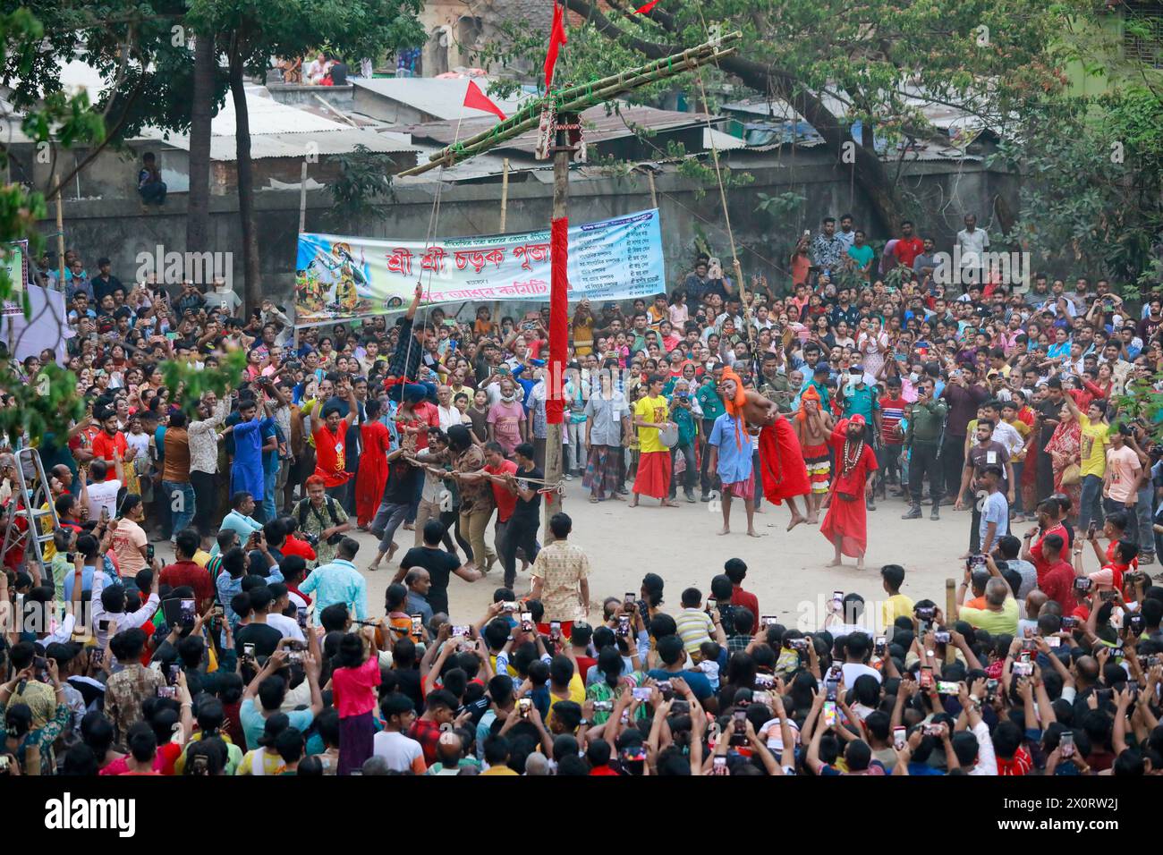April 13, 2024, Dhaka, Bangladesh A Hindu monk swings from a rope tied
