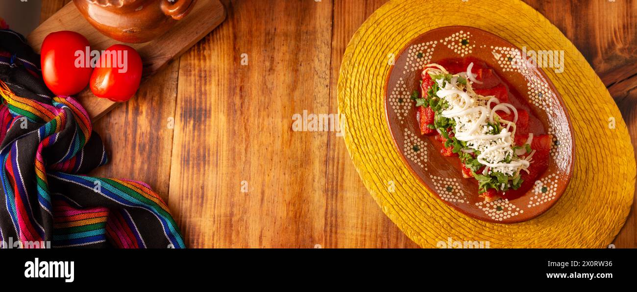 Entomatadas. Also known as Enjitomatadas, a typical dish of Mexican cuisine prepared with corn tortilla, tomato sauce and stuffed with shredded chicke Stock Photo