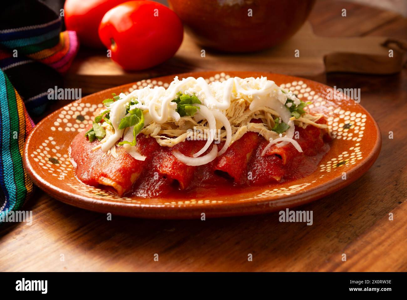 Entomatadas. Also known as Enjitomatadas, a typical dish of Mexican cuisine prepared with corn tortilla, tomato sauce and stuffed with shredded chicke Stock Photo