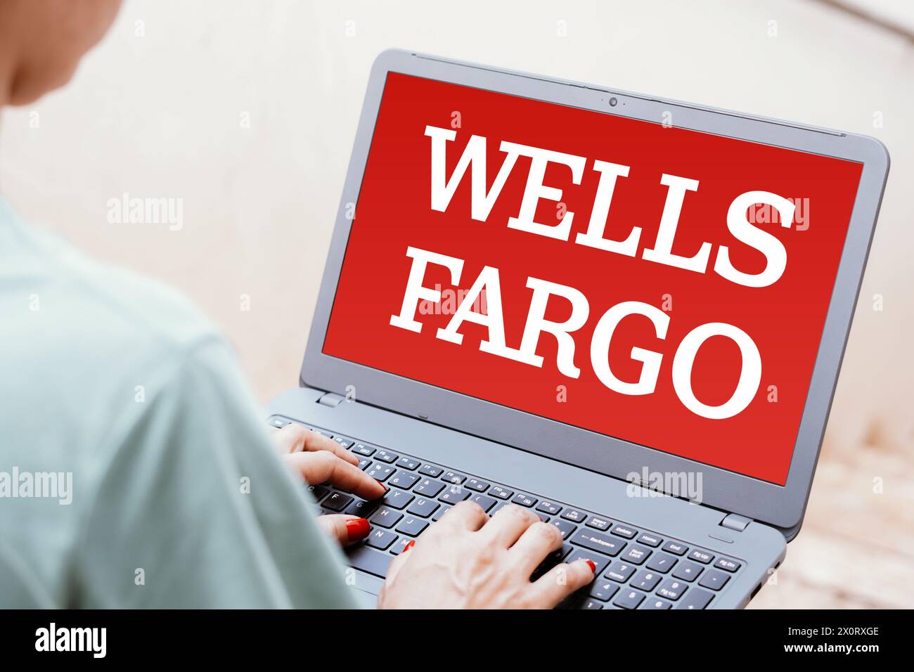 In this photo illustration, the Wells Fargo logo is seen displayed on a laptop screen. Stock Photo