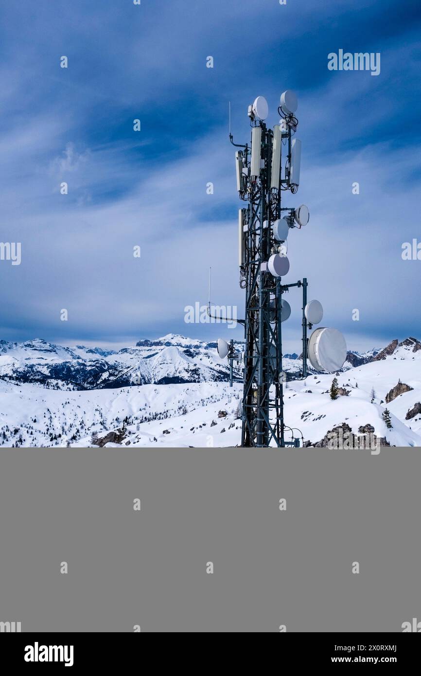 Snow-covered slopes of alpine Dolomite landscape with a telecommunications station above Giau pass in winter. Cortina dAmpezzo Veneto Italy FB 2024 10 Stock Photo