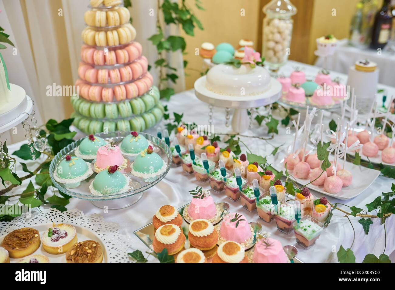 Macaron tower or pyramid and cupcakes on sweet dessert table Stock Photo