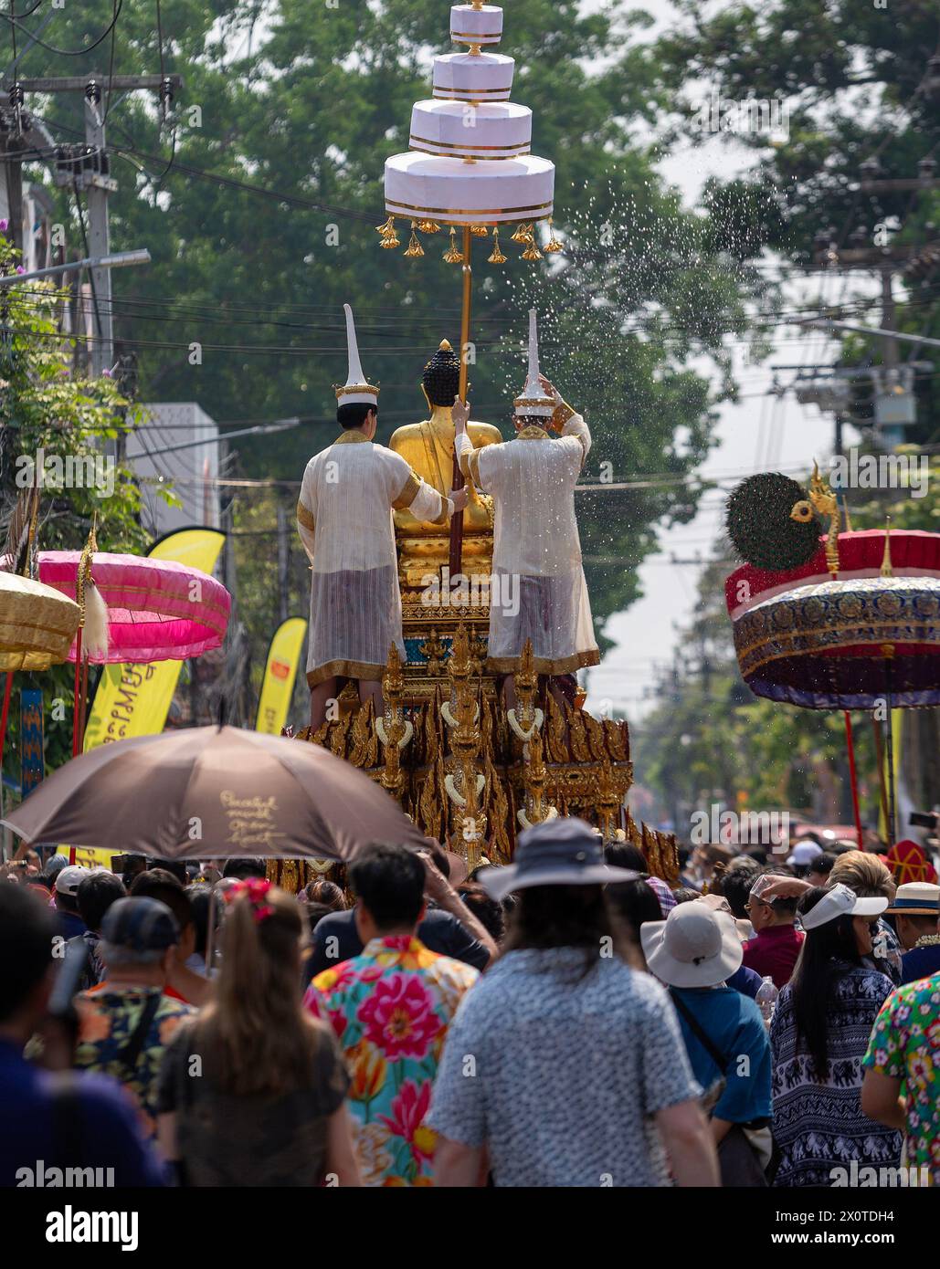 Thai people wearing traditional costumes seen during The Phra Buddha Sihing Buddha statue procession to mark Songkran celebrations at Wat Phra Singh Woramahaviharn temple. The festive Songkran is also known as the water festival which is celebrated on the Thai traditional New Year's day annually on 13 April by spraying water and throwing powder at each others faces as a symbolic sign of cleansing and washing away the sins from the past year. Stock Photo