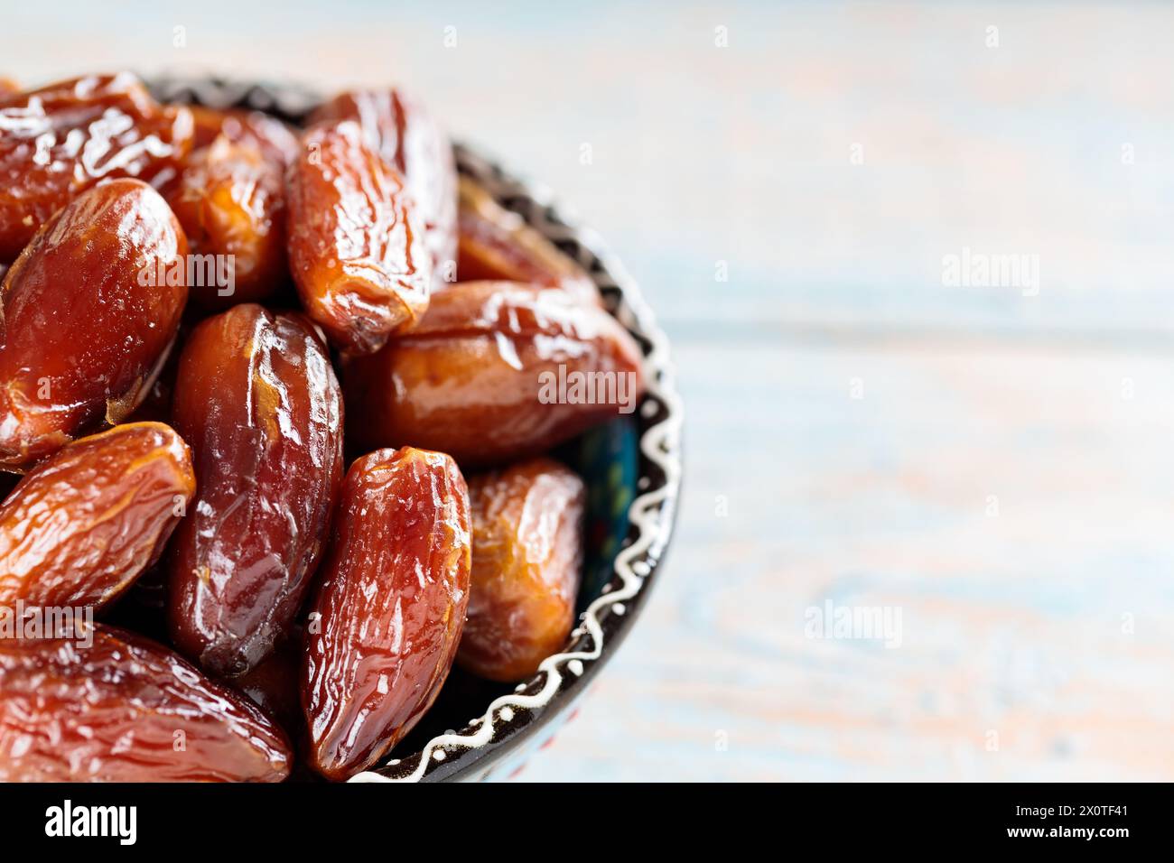 Dried Dates in Bowl on Wooden Boards, Copy Space Stock Photo