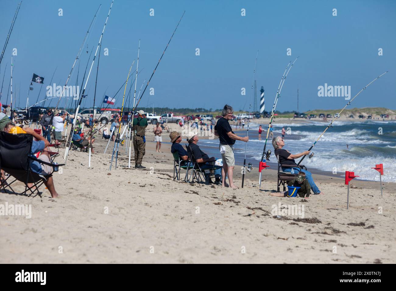 Outer Banks, North Carolina.  Cape Point Fishermen.  Cape Hatteras lighthouse in distance. Stock Photo