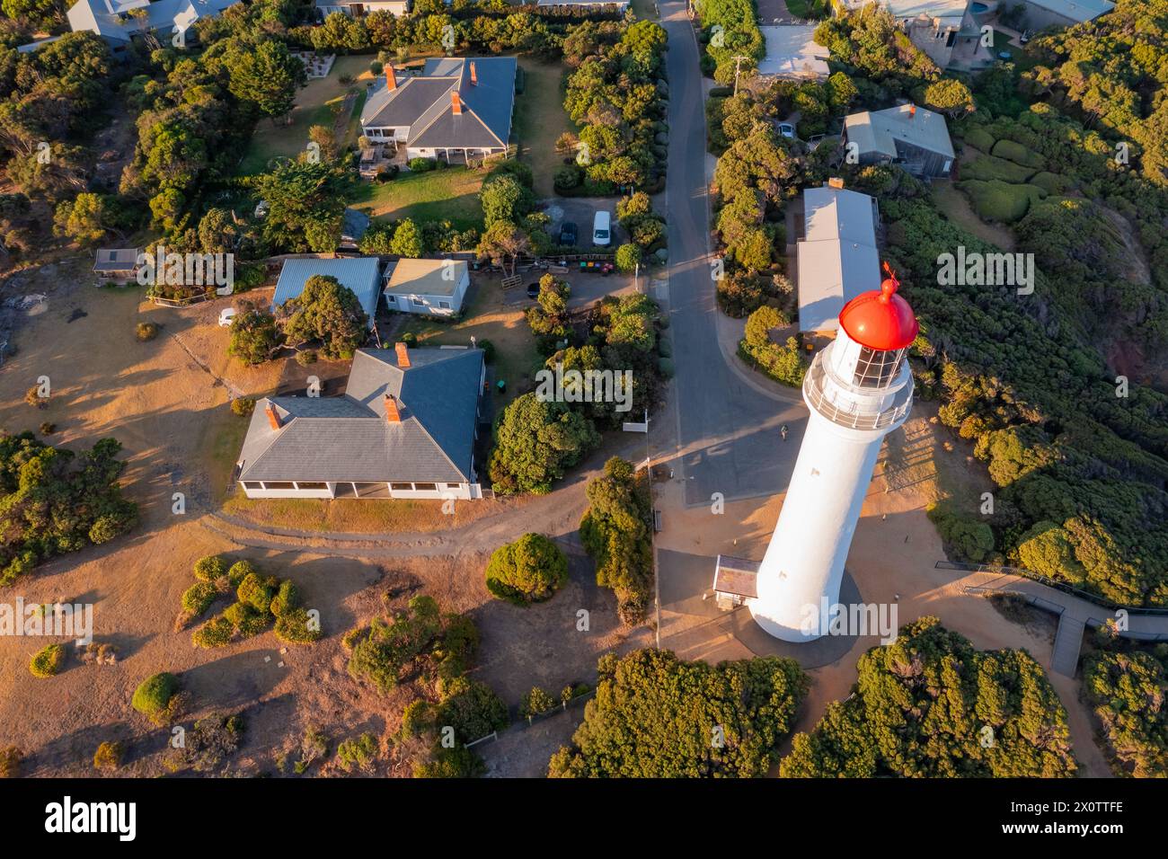 Aerial view above a tall white lighthouse at Aireys Inlet on the Great ...