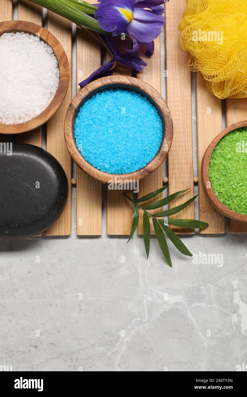 Flat lay composition with natural sea salt on grey marble table. Space ...