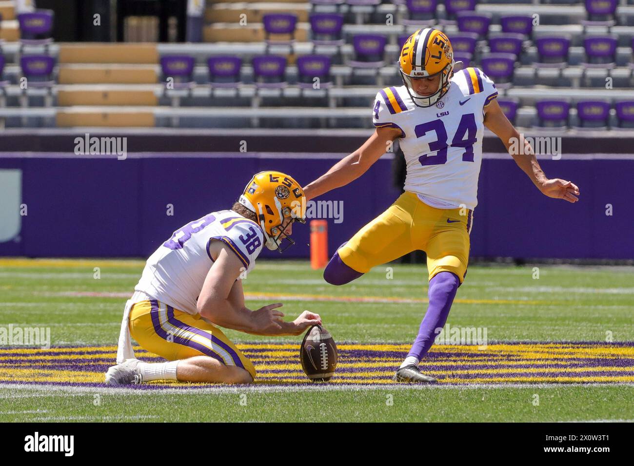 Baton Rouge, LA, USA. 13th Apr, 2024. LSU placekicker Damian Ramos (34) attempts a field goal out of the hold of teammate Peyton Todd (38) during the annual National L Club LSU Spring Game at Tiger Stadium in Baton Rouge, LA. Jonathan Mailhes/CSM/Alamy Live News Stock Photo