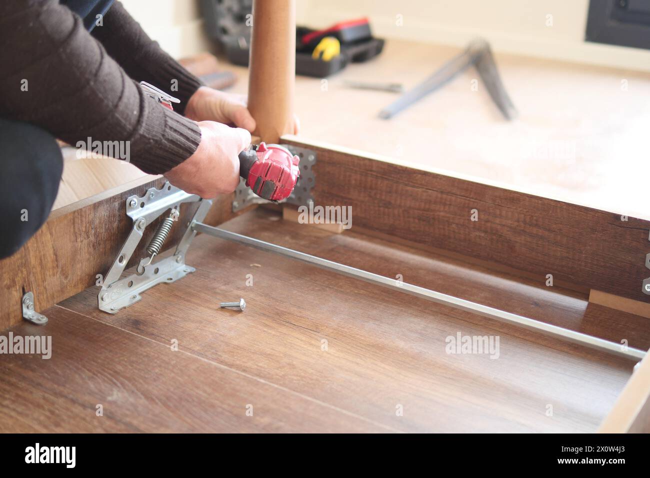 using electric drilling on wooden table  Stock Photo